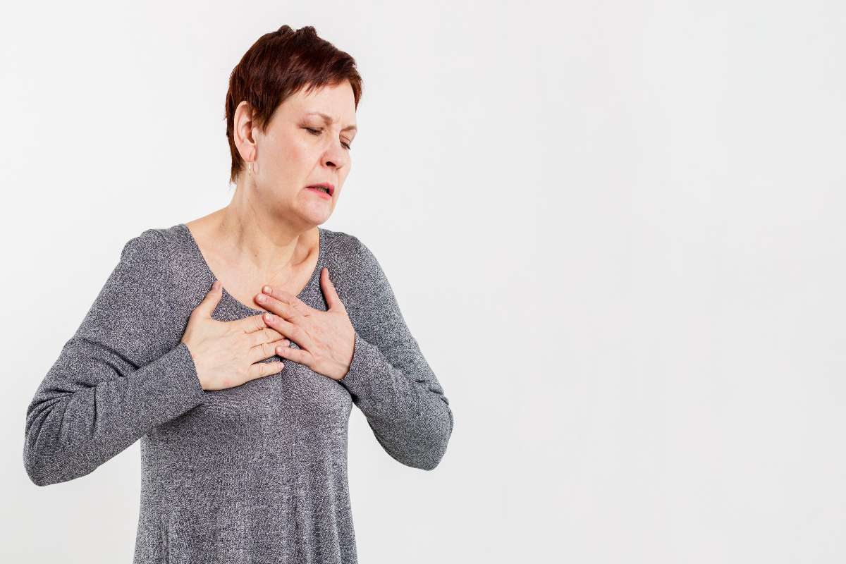 A woman experiencing chest pain.