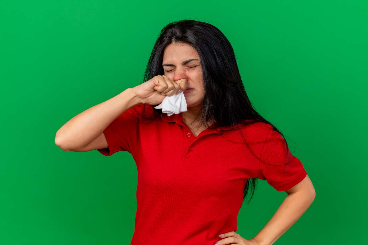 A girl in red t-shirt suffering from congestion.