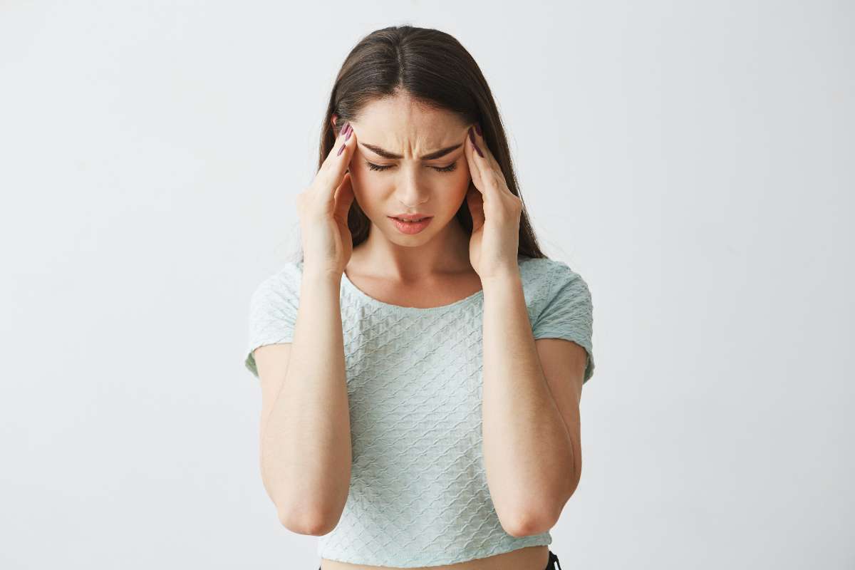 A girl experiencing headache due to stress symptom.