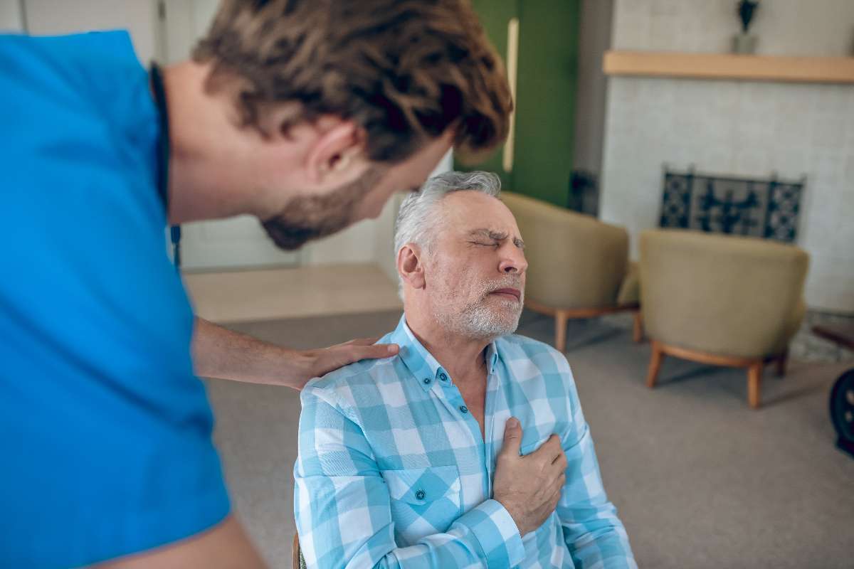An old man experiencing heart stroke because of stress.