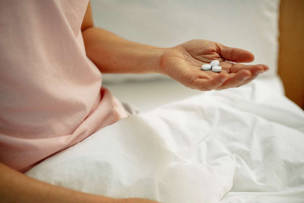 A patient holding medicines in hand to cure his health problem