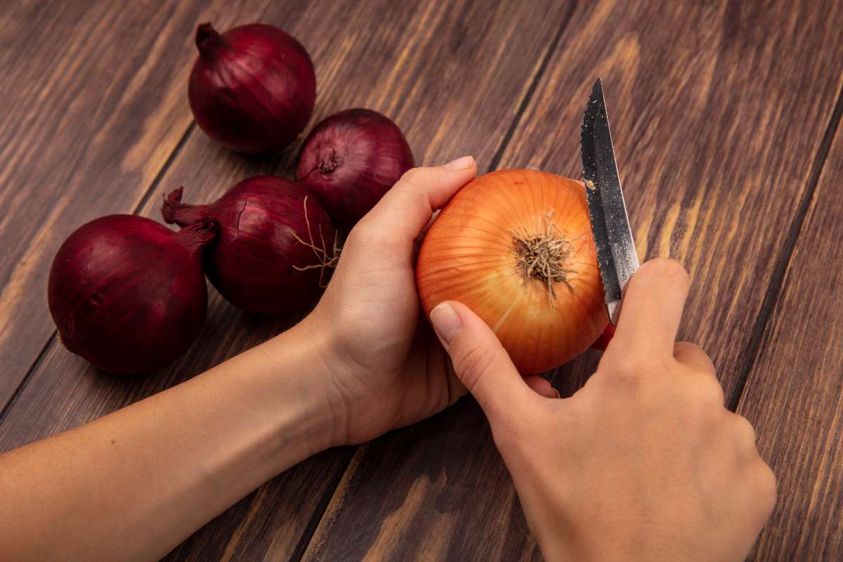 A girl peeling onion to prepare hair mask for hair growth.