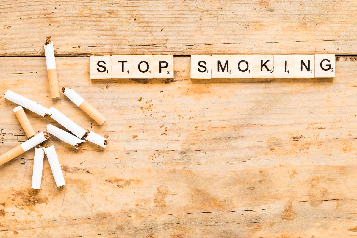 Stop smoking written on the table with cigarettes to prevent Cough.