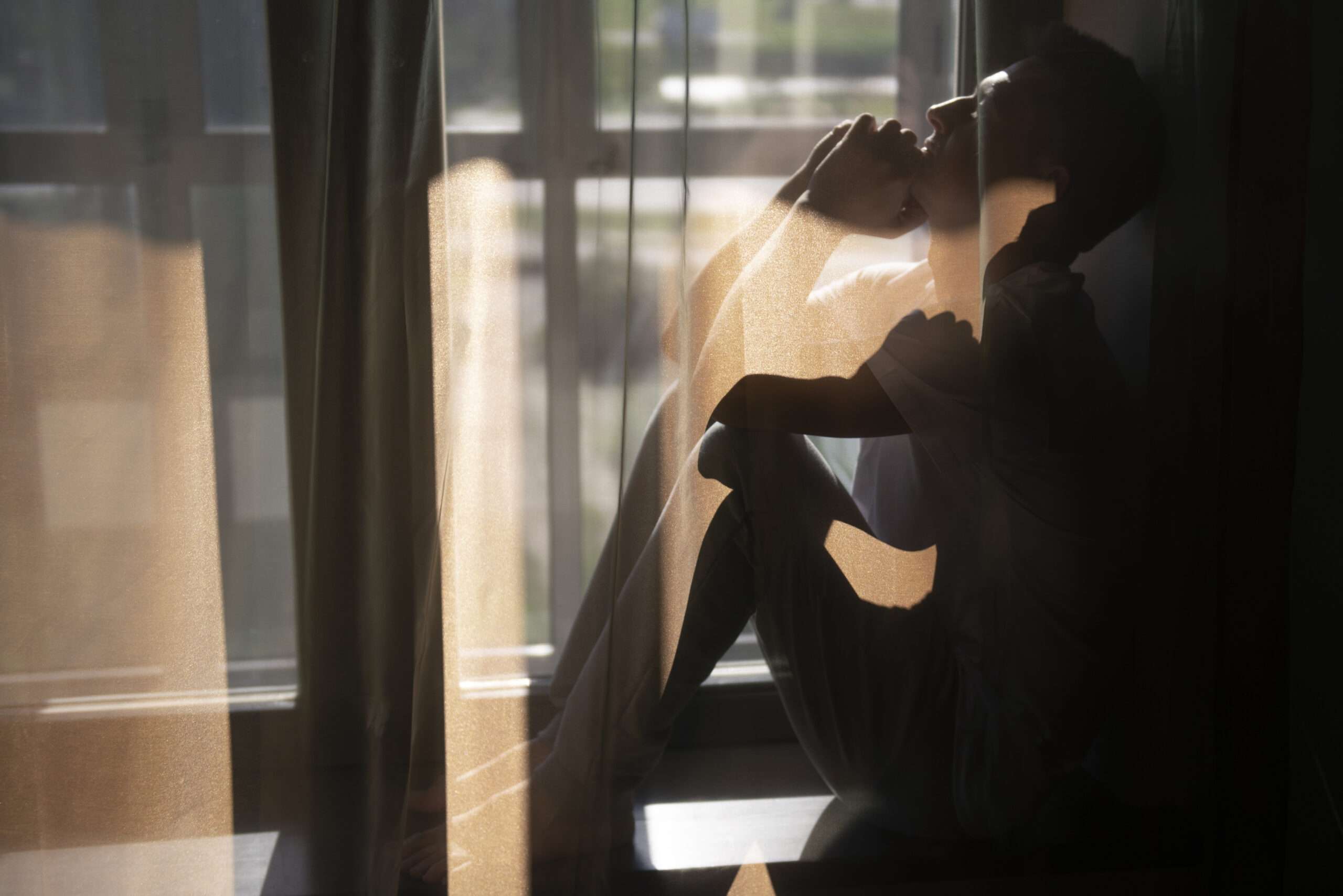 A person feeling lonely and suffering from social isolation.